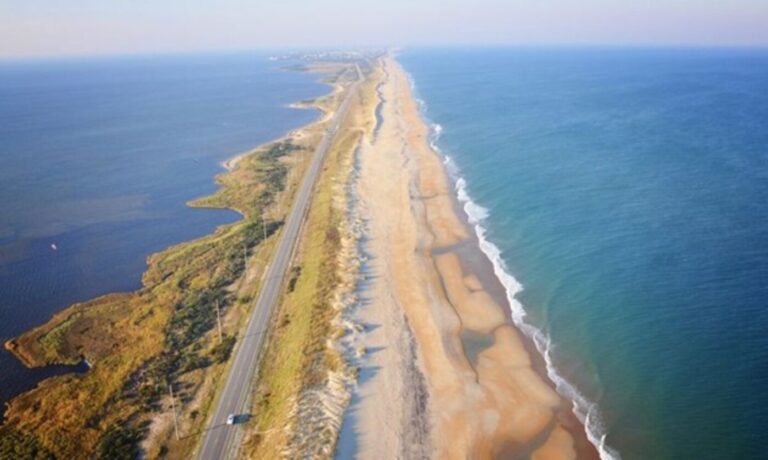 An aerial view of a portion of the Outer banks highway with a view of the beach for waterside road trips