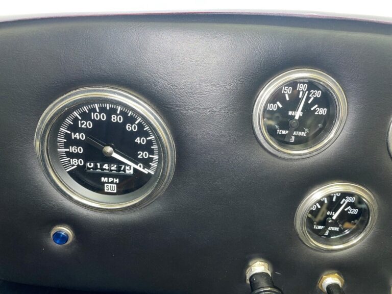 A Cobra dashboard section showing the speedometer, water temperature and oil temperature gauges
