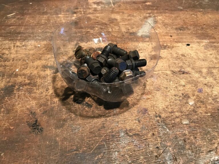A container of header bolts in preparation for putting parts back together
