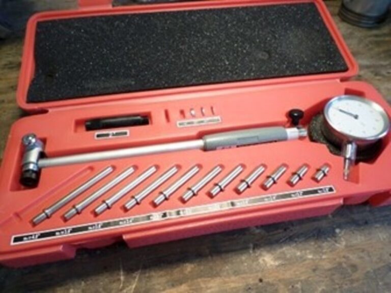 A tolerance measuring tool in a red carrying case for working on the engine rebuilding factors of complexity