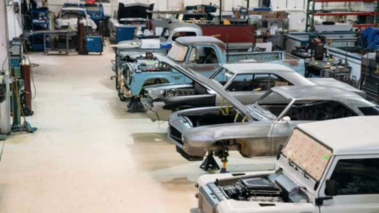 A restoration shop wit ha line up of partial restored Landrovers, Camaros and Dodge trucks showing the restoration shop risk
