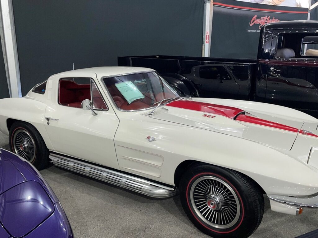 White with red stripe and chrome side pipes 1967 Chevy Corvette at an auction knowing that informed classic car buyers do better