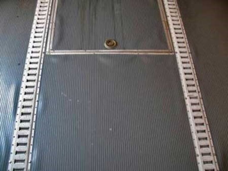 A metal track securing system installed on the floor of an enclosed car trailer
