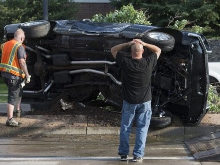 A Ford Mustang flipped on its side after a car accident requiring vintage car insurance