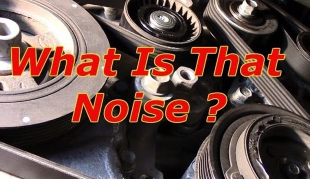 The front of a car engine with the belts and pullies with red letters "What Is That Noise" referring to car engine noise