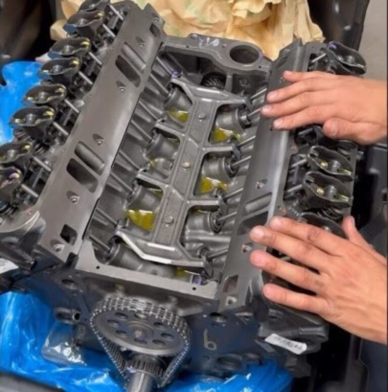 A mechanic inspecting a new chevy engine block to help avoid any possible car engine noise