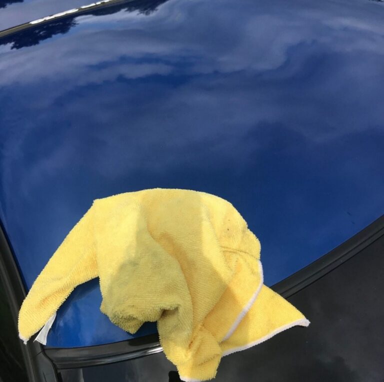 A blue roof of a C5 Corvette with yellow towel after car washing and drying