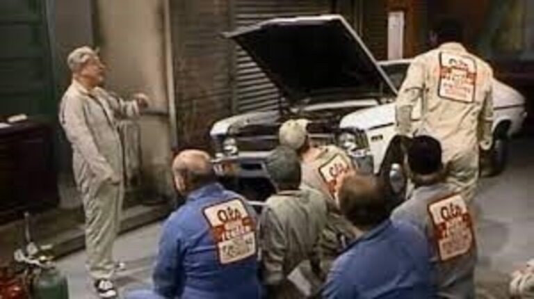 TV show with actors in overalls discussing working on a vintage car; delays in work are often not reporting shop scams