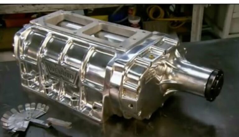 A chrome Weiland supercharger on a work bench noting the roots style for supercharging a car engine