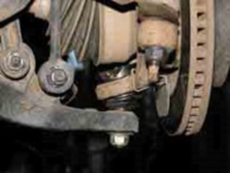 Vented disc brake rotor mounted on the front suspension of a car