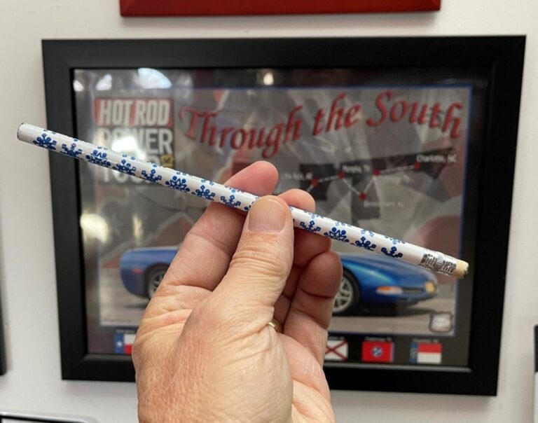 Using a white pencil to demonstrate a car under acceleration with the front of the car lifting moving the car's weight distribution to the rear.