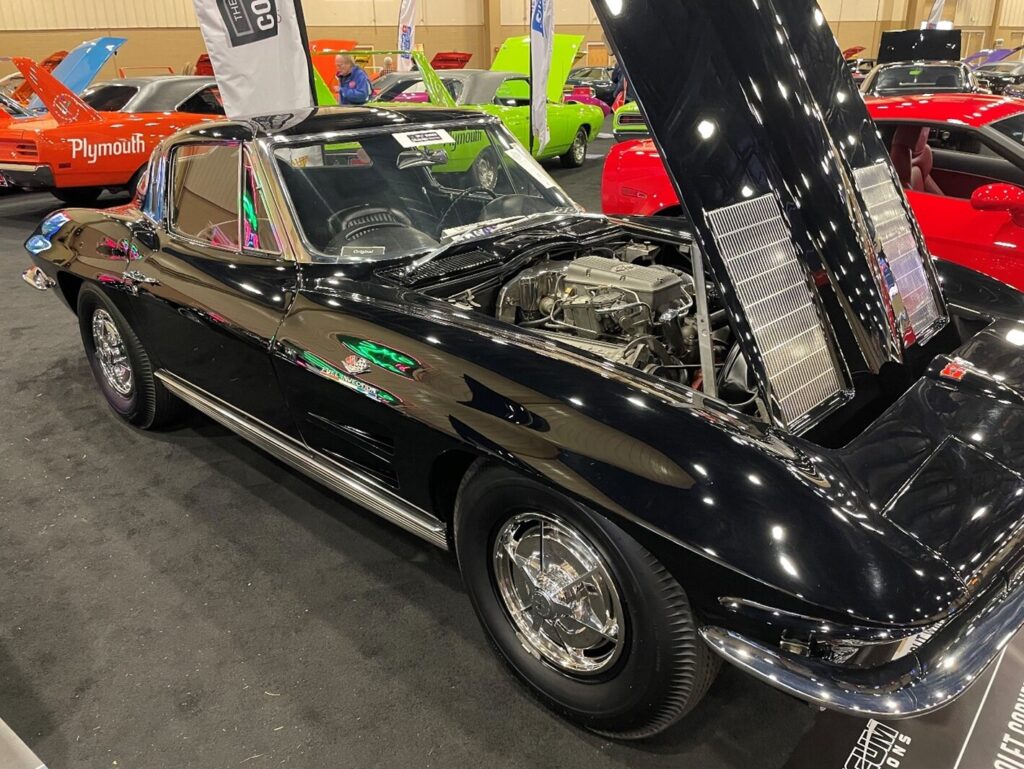 A black on black 63 Chevy Corvette sitting at an auction after restoration getting a written agreement was crucial