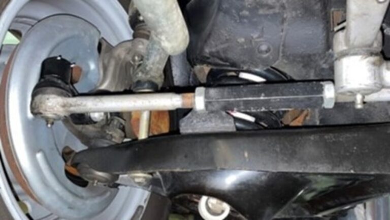 The steering mechanism and control arms for the front suspension of a Chevrolet car that are adjusted as part of the car wheel alignment process