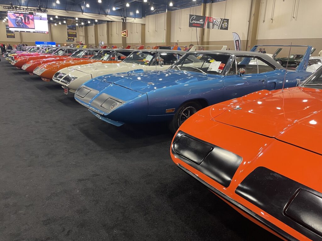 A row of Plymouth Superbirds at an auction of classic cars