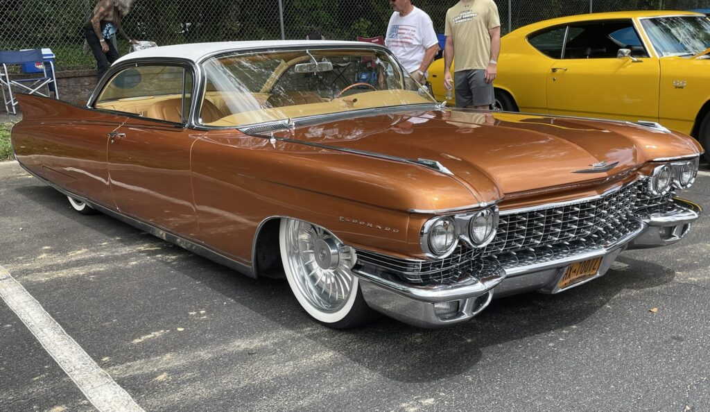 A gold custom Cadillac with a modified engine and automatic transmission