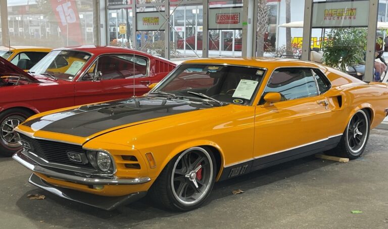 A yellow and black Ford Mustang customized into a resto-mod