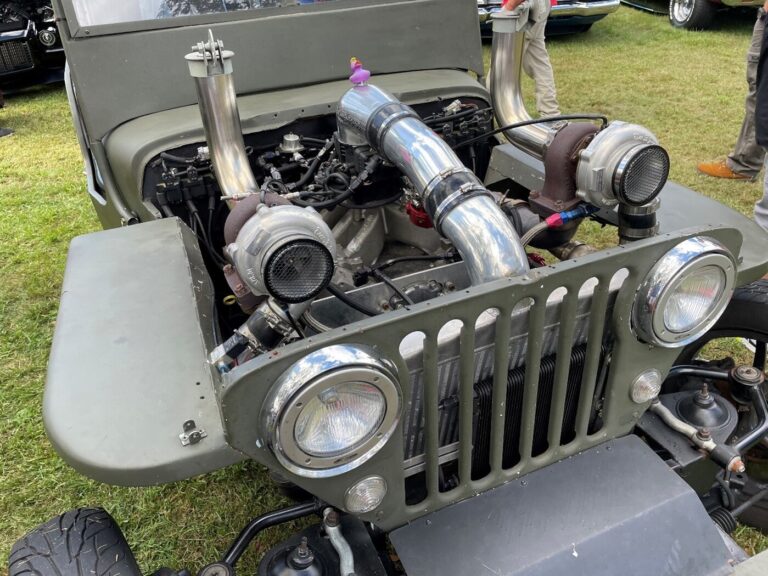 A green Willys Jeep with a twin turbo-charged engine