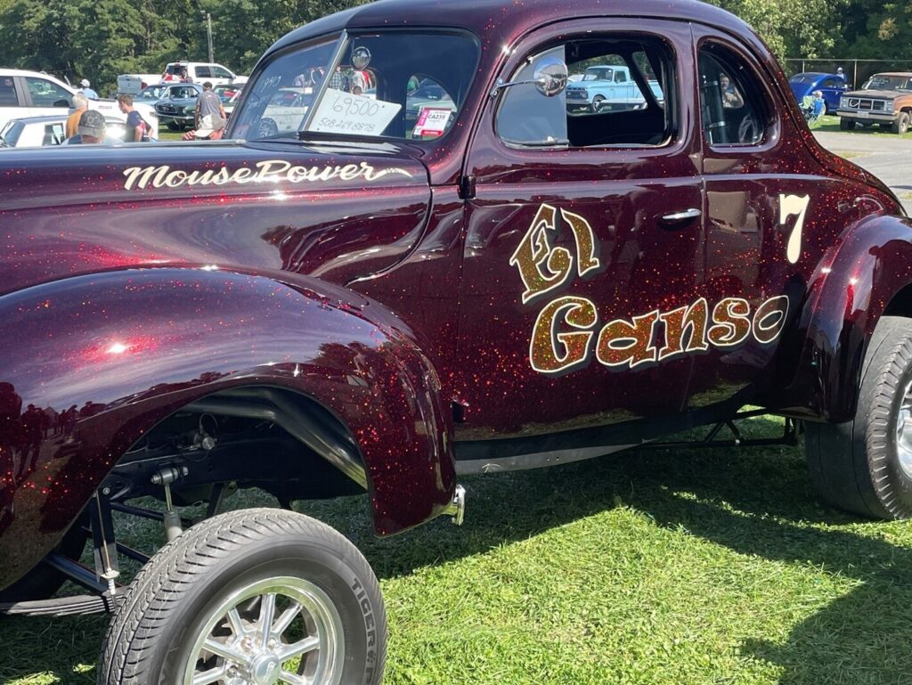 A Candy Apple with metal flake paint job with El Ganso written on the side 1941 Willy's coupe for sale requiring a pre-purchase checklist to be completed before buying