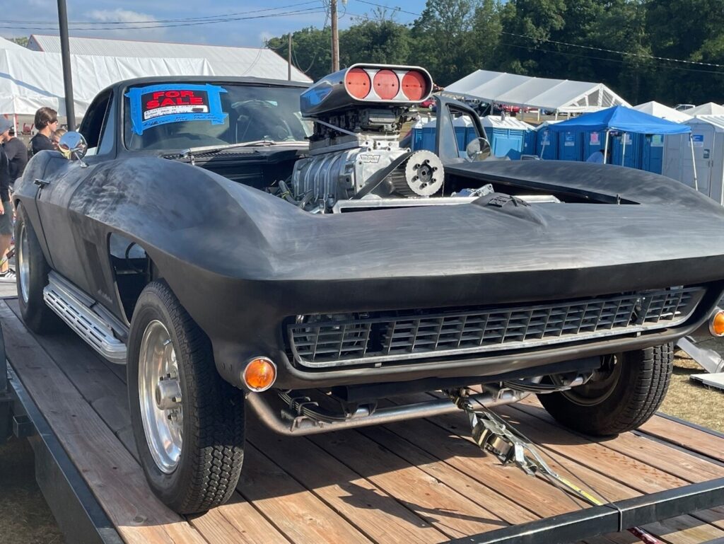 A primer gray C2 Corvette with major modifcagtion mistakes like body changes and supercharger thru the hood
