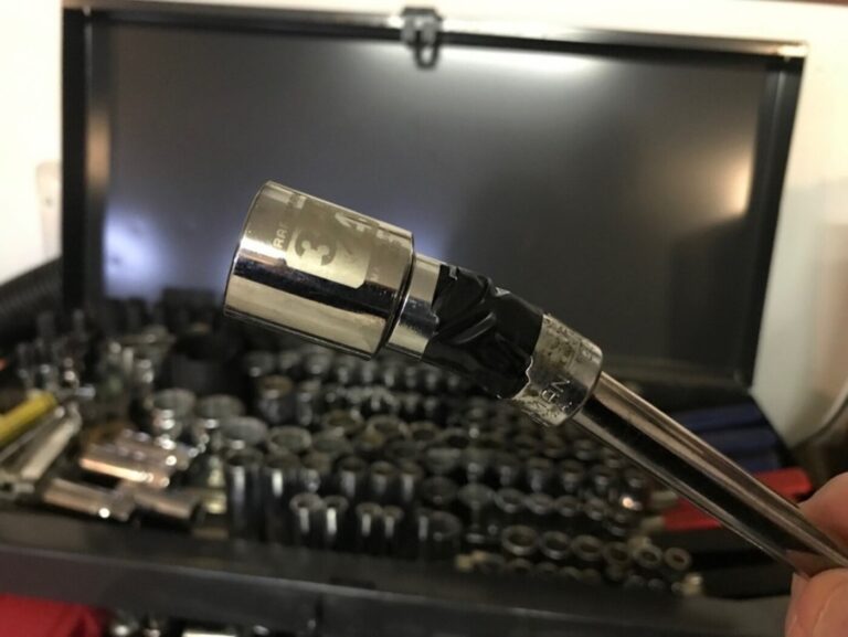 A 3/4 socket on the end of a extension as part of essential tools for car repair