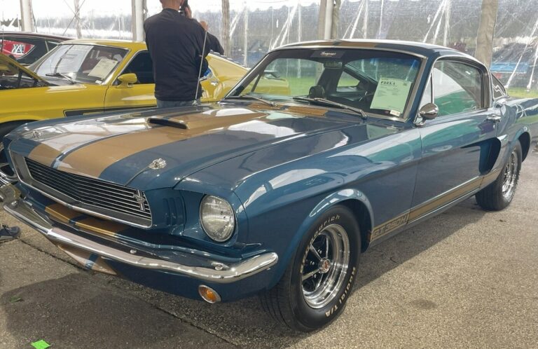 A blue with gold stripes Ford Mustang as an example of an American pony car