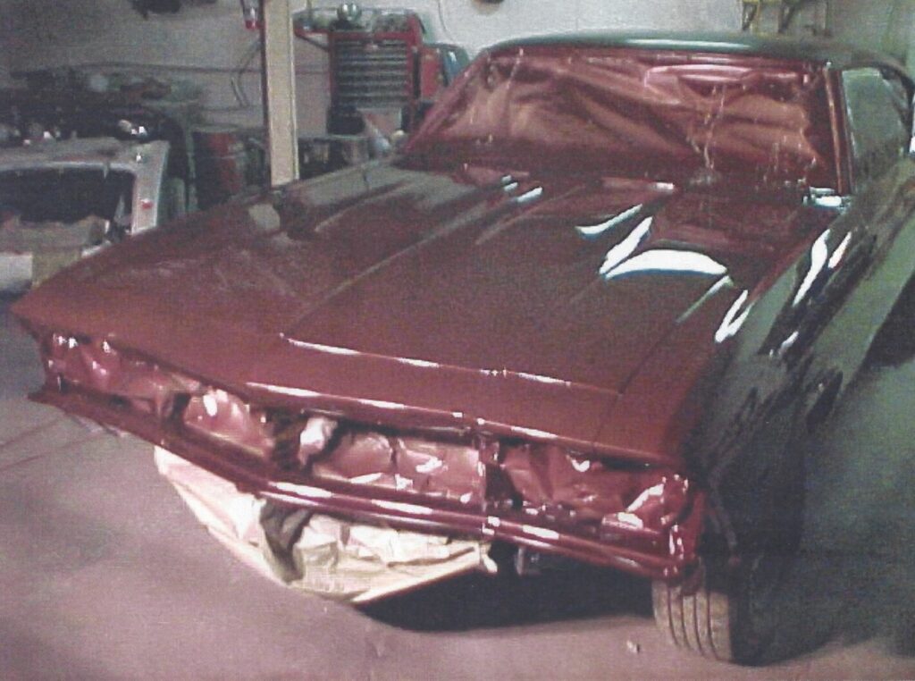 A freshly painted maroon 68 Chevy Chevelle being worked on at a reputable car paint shop