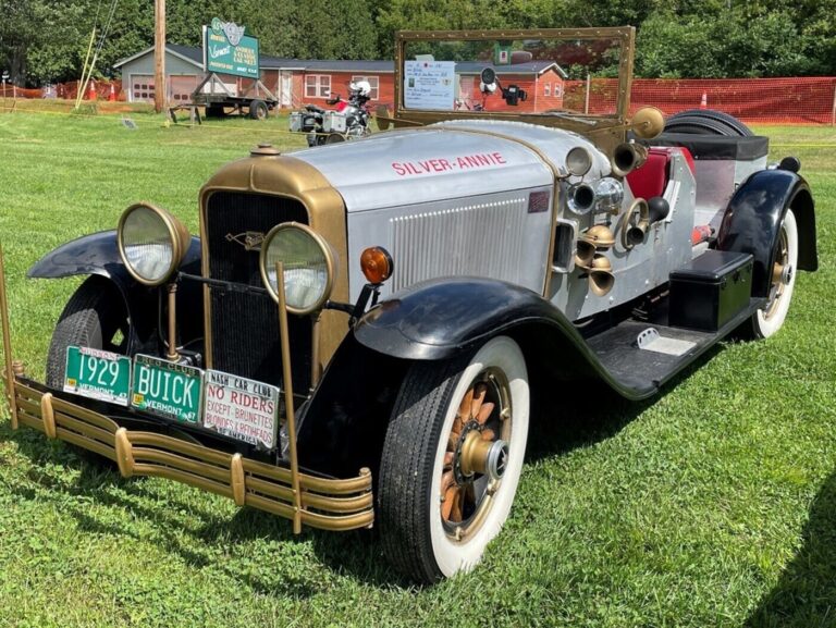 A silver and black 1929 Buick with Vermont license plates on display at a classic car show as part of the vintage car hobby