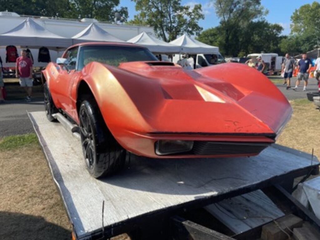 An orange partially customized 1969 Chevy Corvette on a trailer looking for the right restoration direction