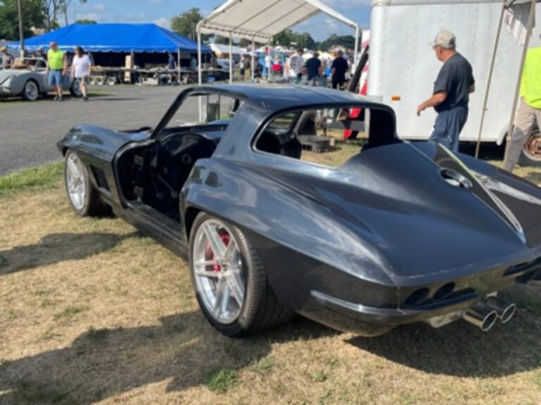 A partially Customized gray 1966 Chevy Corvette resto-mod at a car show looking for the right restoration direction