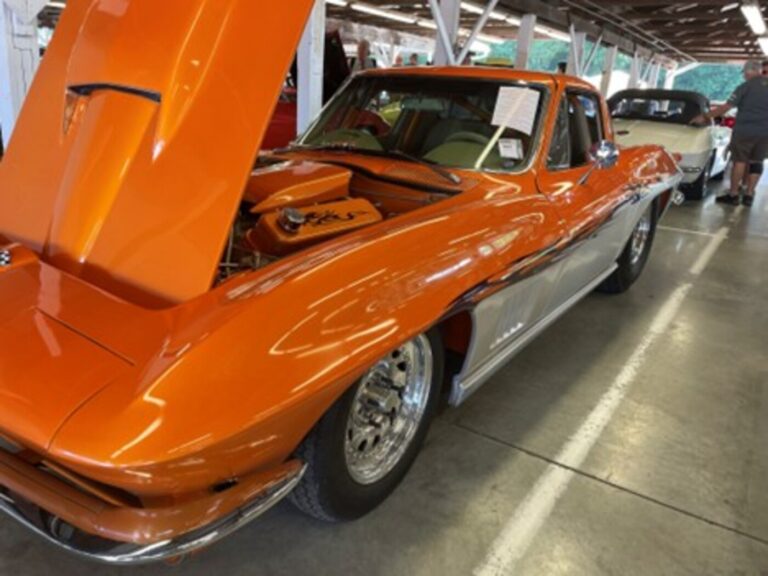 An orange and white 1969 Chevy Corvette that used a restoration direction converting the car to a pro-street driver