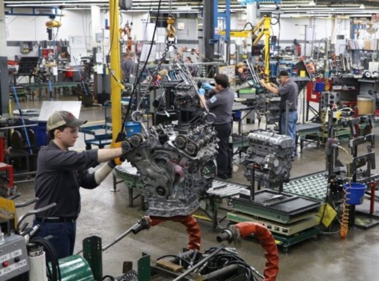 Machinist working on remanufactured engines inside a machine shop