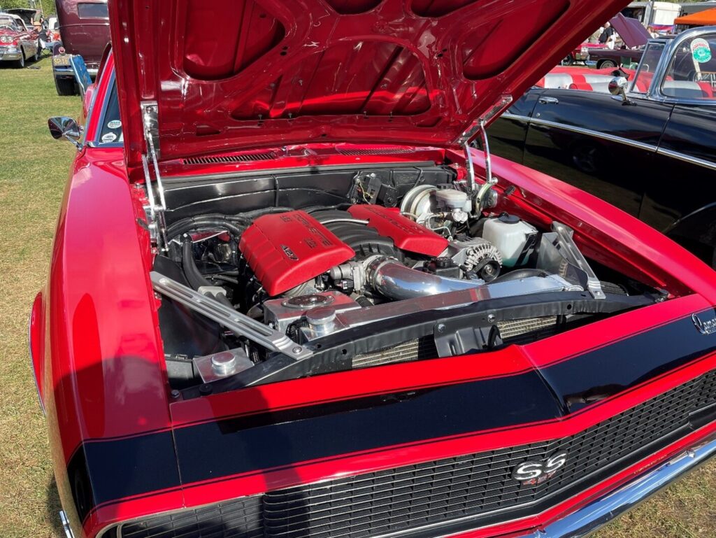 A 69red Chevy Camaro with a modern Chevrolet LS engine installed.