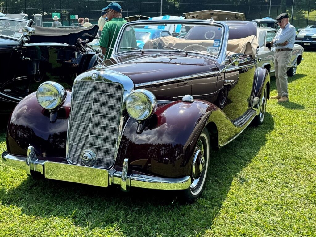 A burgundy 1940s Mercedes Benz vintage car restored to a concours restoration condition