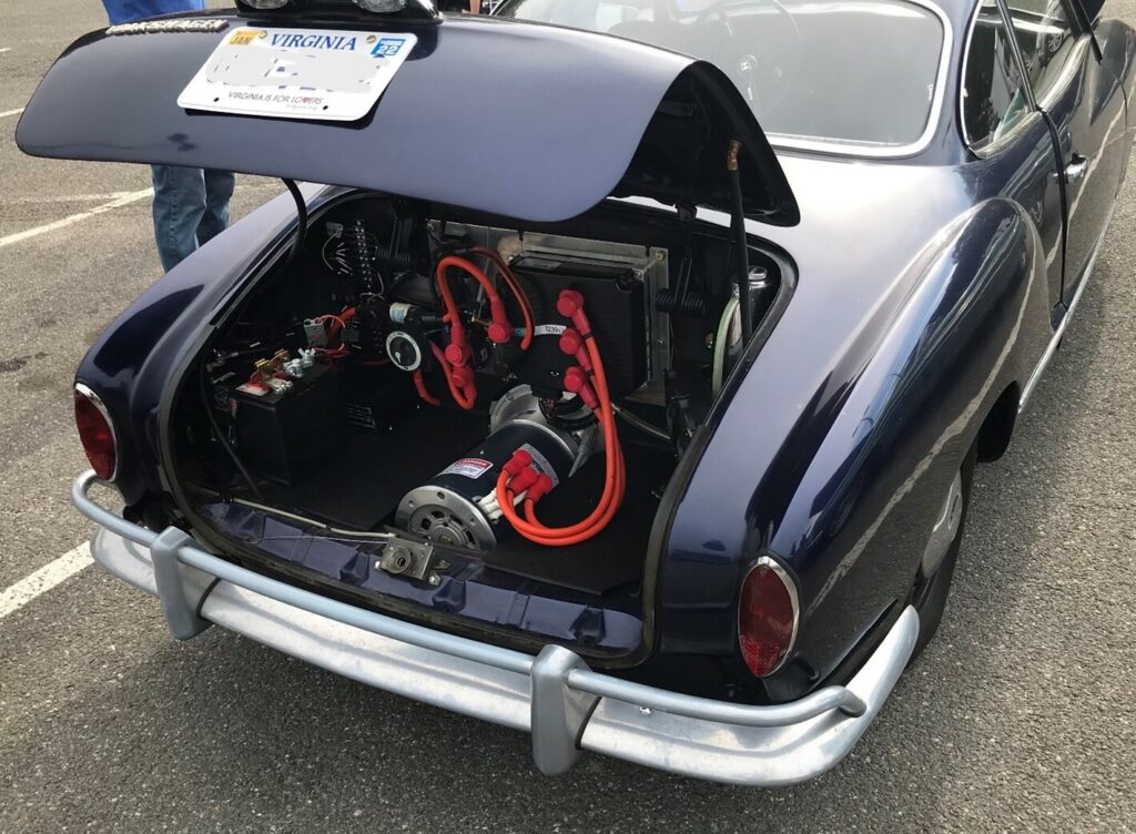 A black VW Ghia with a newly installed electric classic car motor in the rear engine bay