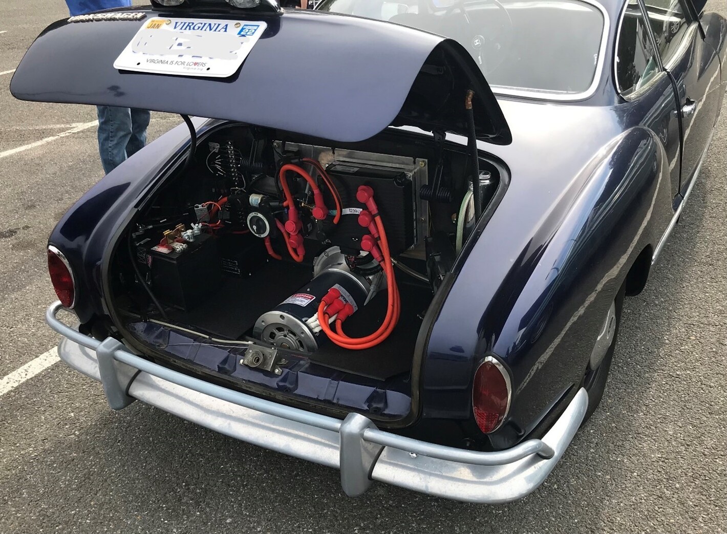 A black VW Ghia with a newly installed electric classic car motor in the rear engine bay