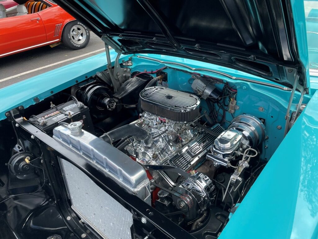 A chromed-out Chevy stroker engine in a light blue 57 Chevy