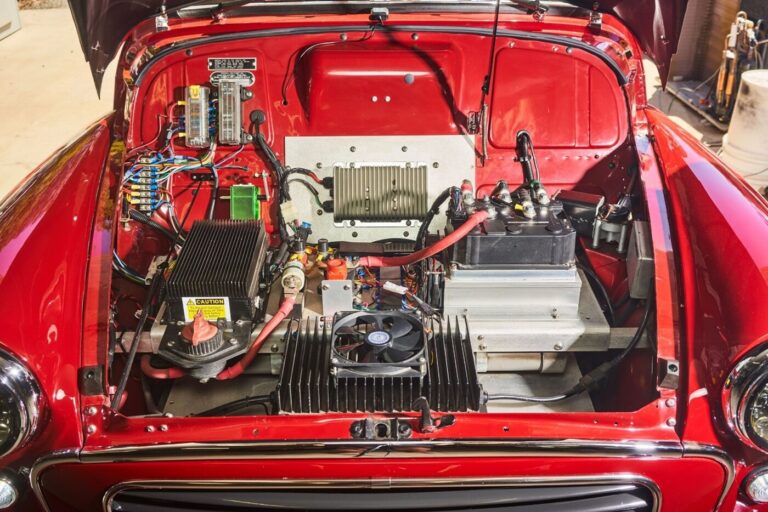 Under the hood of a red vintage car is the electric classic car motor conversion
