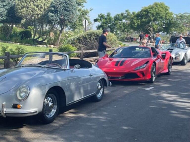 A white Porsche, red Ferrari, and silver Cobra on a California street for retirees who enjoy classic cars