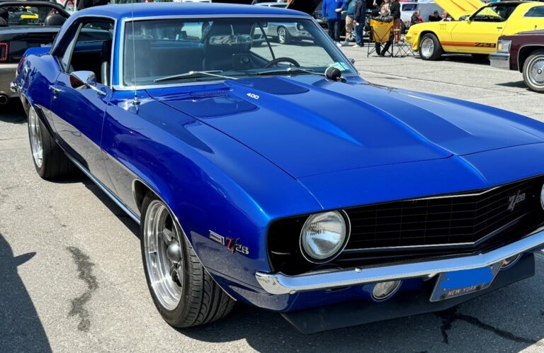 A custom blue 1969 Chevy Camaro at a car show which is a favorite of the Baby Boomer Generation