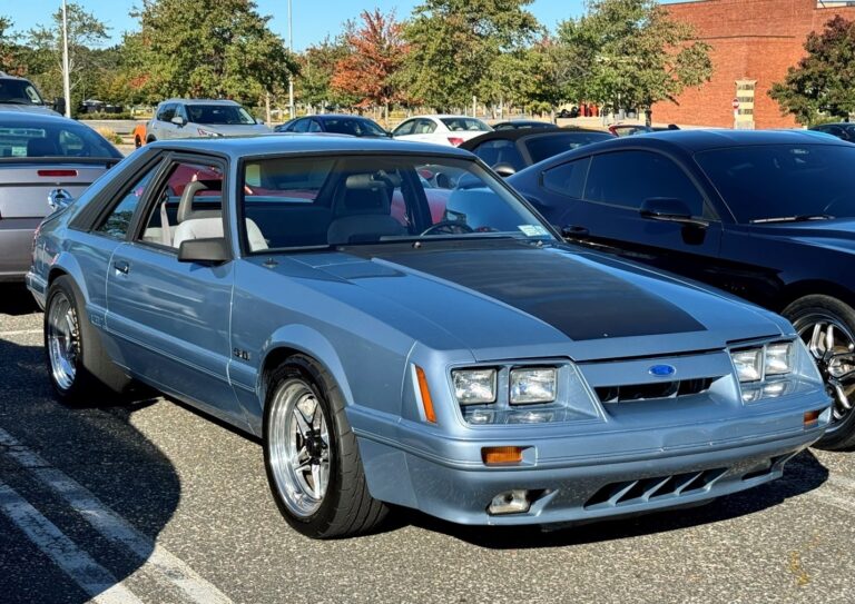 A blue ox body Ford Mustang at a car show which is a favorite of the Millennials generation