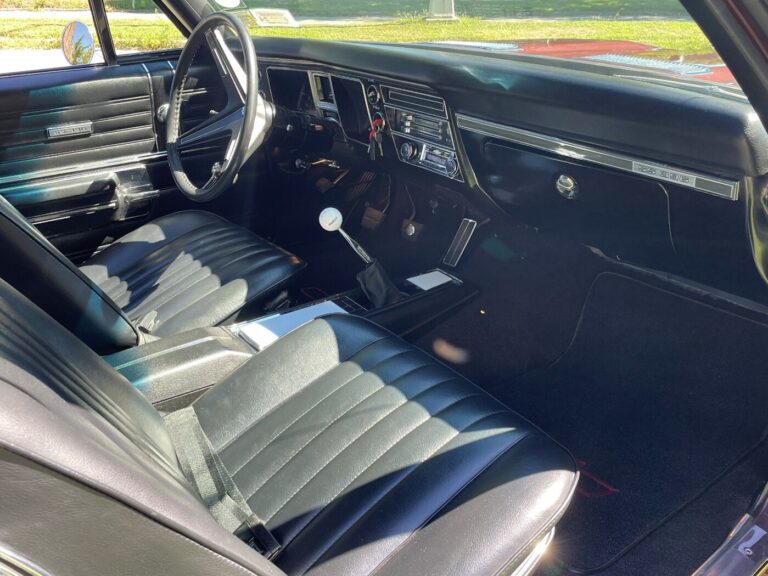 A view of the front seats and dash from the passenger side of the black interior in a 1968 Chevy Chevelle